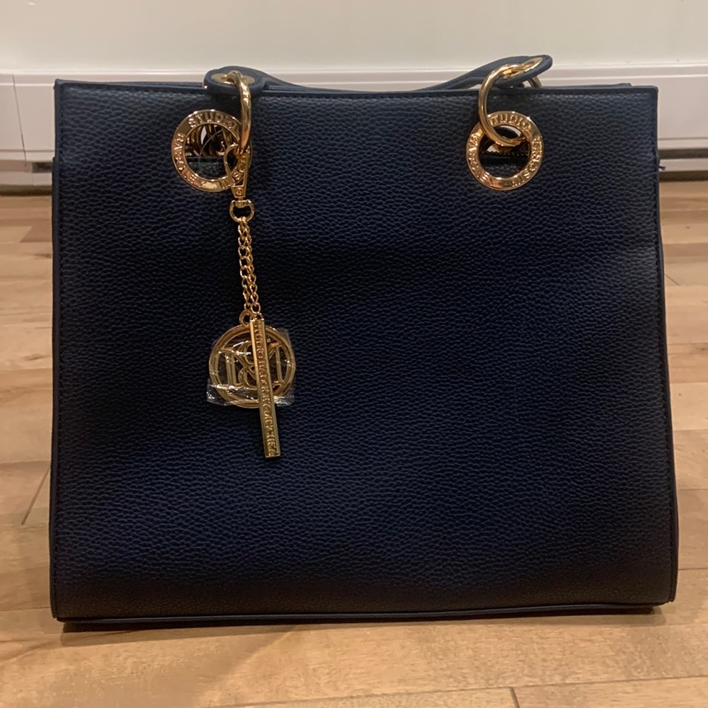 Navy blue purse, brand new and never used. The brand is studio badgley mischka.